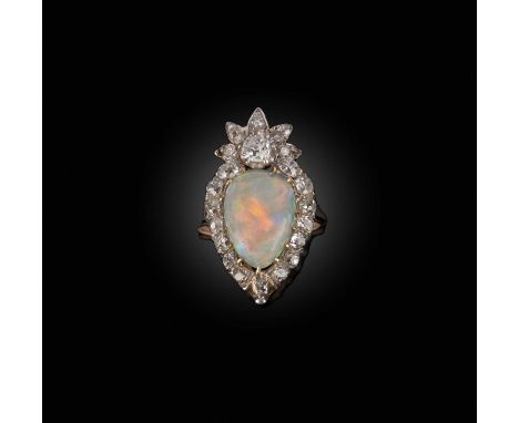 An opal and diamond ring, designed as a flaming heart motif, set with a pear-shaped cabochon opal weighing 2.54 carats, withi