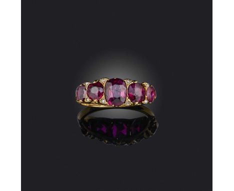 A late 19th century ruby five stone ring, set with graduated cushion-shaped rubies and diamond pointers in carved and pierced