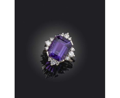 An amethyst and diamond cluster ring, the step-cut amethyst set within quatrefoil border of graduated circular-cut diamonds i