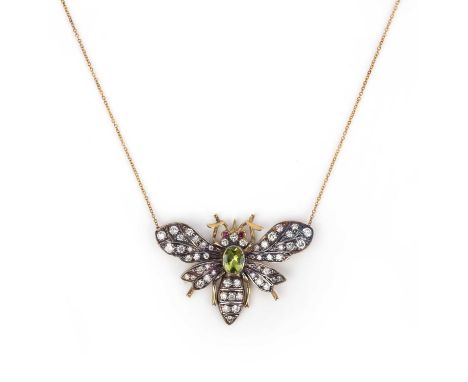 A peridot and diamond bee pendant, set with graduated diamonds and ruby eyes with an oval peridot body in silver and gold, wi