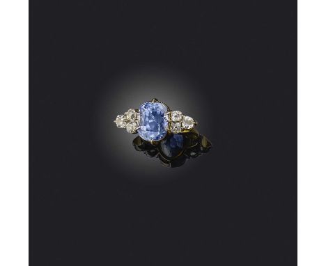 A sapphire and diamond seven stone ring, set with a cushion-shaped sapphire within diamond-set shoulders in platinum and gold