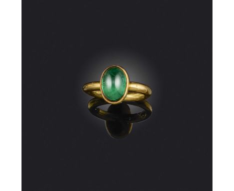 An emerald solitaire ring, the sugarloaf emerald in rubover setting on a polished 18ct yellow gold band, maker's mark and Lon