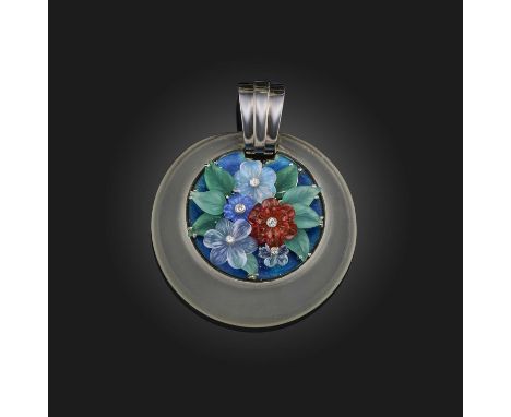 An unusual Art Deco carved hardstone, enamel and diamond pendant, 1930s, of circular outline, centring on a spray of leaves a