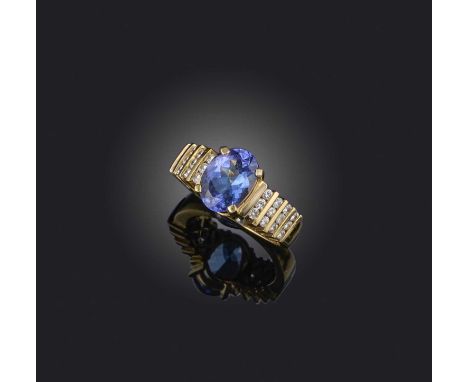 A tanzanite and diamond ring, set with an oval tanzanite within diamond-set shoulders in 14ct gold, size P