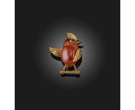 Cartier, a carnelian and emerald brooch, 1950s, designed as a bird in carved carnelian, its eye set with a cabochon emerald, 