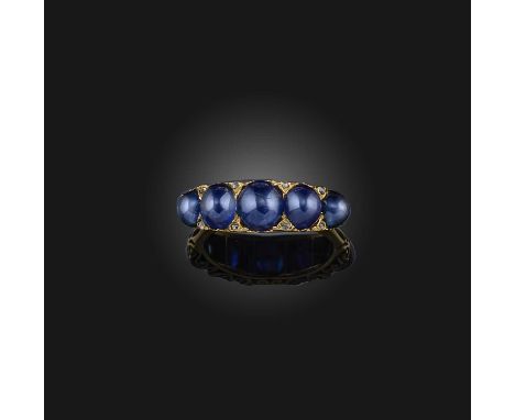 A late 19th century sapphire half hoop ring, set with graduated sapphire cabochons and diamond pointers in carved and pierced