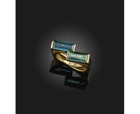 A tourmaline ring, of abstract design, set with two step-cut tourmalines in polished yellow gold setting, size M