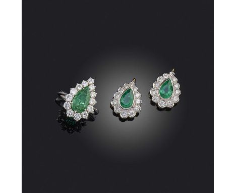 A pair of emerald and diamond drops and ring, each set with a pear-shaped emerald within a border of diamonds, the drops set 