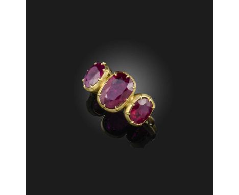 A ruby three-stone ring, set with three cushion-shaped rubies totalling approximately 4.00 carats, in gold collet settings, s