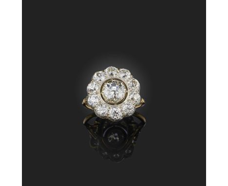 A late 19th century diamond cluster ring, set with graduated old circular-cut diamonds in silver and gold cut-down collets, s