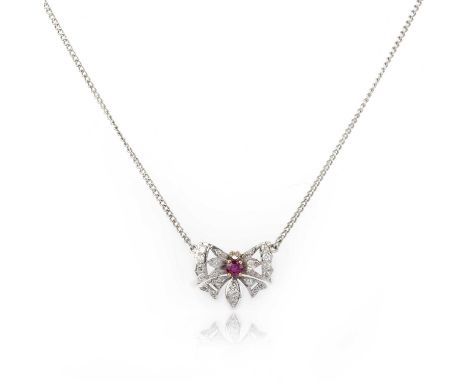 A ruby and diamond pendant necklace, designed as a butterfly, set with a circular-cut ruby and brilliant-cut diamonds, to a c