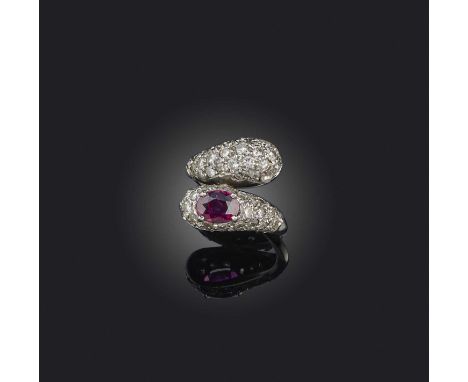 A ruby and diamond ring, mid 20th century, of crossover design, each bombé end pavé-set with brilliant- and single-cut diamon