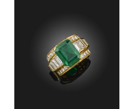 An emerald and diamond dress ring, the step-cut emerald measuring 12.3 x 9.6 x 6mm and weighing approximately 4.80 carats, se