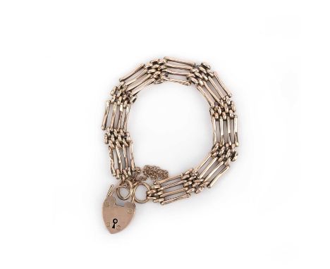 A gold bracelet, circa 1908, composed of gate linking, to a heart-shaped padlock clasp, length 19cm, British hallmarks for 9c