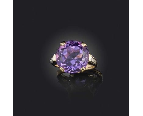An amethyst and diamond ring, claw-set with a circular-cut amethyst, to shoulders set with brilliant-cut diamonds, mounted in