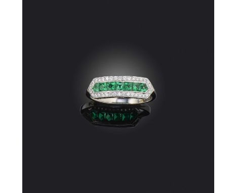 An emerald and diamond half hoop ring, set with French-cut emeralds within a surround of diamonds in platinum, London hallmar