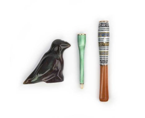 Two cheroot holders and a hardstone carving, comprising: a cheroot holder in gilt metal, applied with green guilloché enamel,