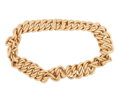 A fancy curb link bracelet, comprising a series of double curb links with engraved pattern details, completed with a conceale