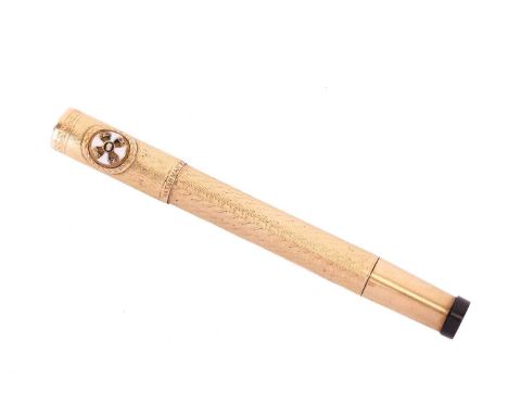 A Waterman's rolled gold fountain pen, with engine-turned design on cap and barrel, applied with enamelled roundel depicting 