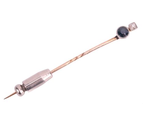 An Art Deco sapphire and diamond stick pin, featuring an old mine-cut diamond above a circular-cut sapphire, both set in mill