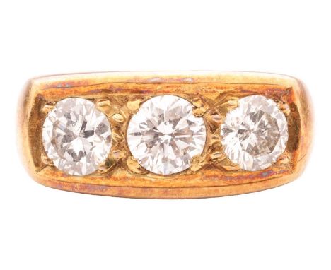 A Diamond three stone ring in 14ct gold, featuring a central 6.0 X 3.85mm round brilliant cut diamond flanked by two further 
