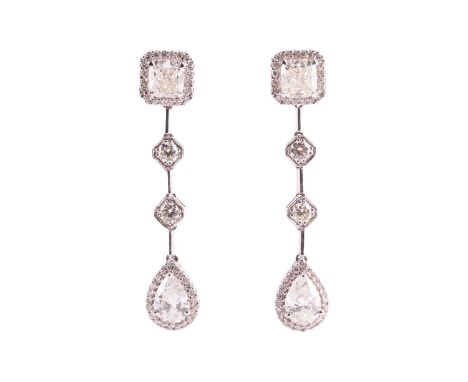 A pair of diamond set drop earrings, featuring two claw set cushion cut diamonds measuring 6.09x5.59mm and 6.00x5.51mm respec