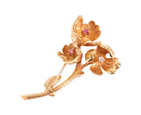 A diamond and ruby floral spray brooch, circa 1968, realistically modelled as a flower stem, the centre of each bloom set wit