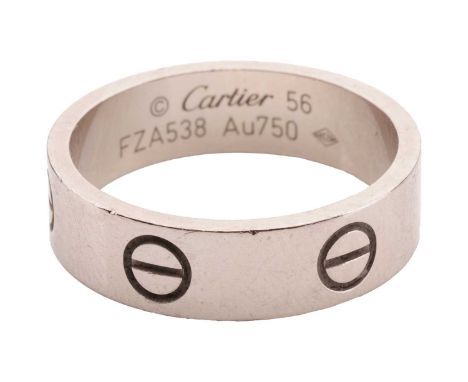 Cartier- a 'Love' ring with polished white metal band, decorated with screw head motifs, signed, numbered and marked 'Au750',