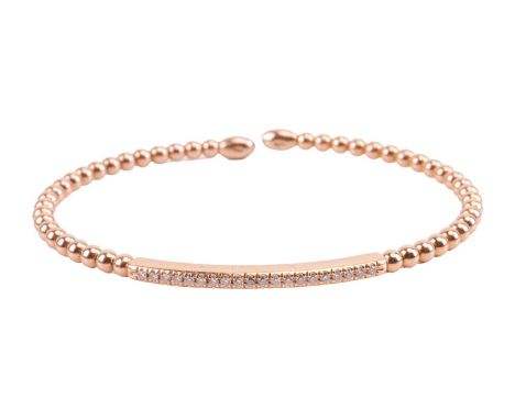 A diamond-set torque bangle, comprising of an open wire strung with beads, centred with a curved panel set with a row of diam