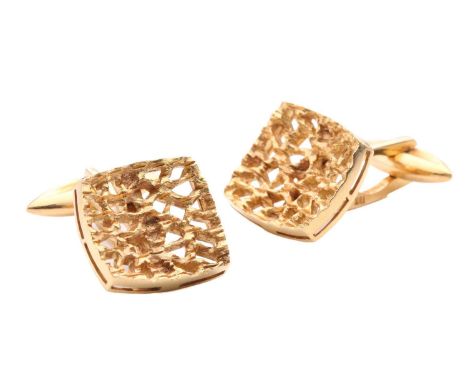 A pair of Modernist style cufflinks with organic textures, the concave openwork panels of cushion shape, suited with toggle f