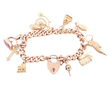 A charm bracelet in 9ct rose gold, composed of a series of hollow curb links, suspending with ten charms, some gilt, some wit