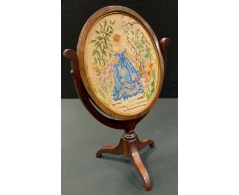 A 19th century mahogany oval dressing table mirror, oval frame, the back with tapestry, embroidered with a lady wearing a blu