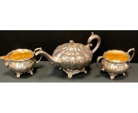 A silver plated Victorian style composed three-piece tea service of melon form, the milk and sugar with gilt interiors, the t