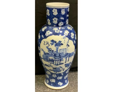 A large 19th century Chinese blue and white Kangxi style temple jar vase, painted with traditional motif panels. blossoming g