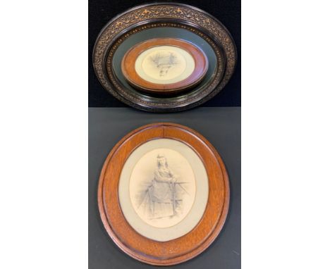 A Victorian oval looking glass, ornate carved floral frame, gilt detailing, 42.5cm x 32cm;  oval photograph portrait (2) 