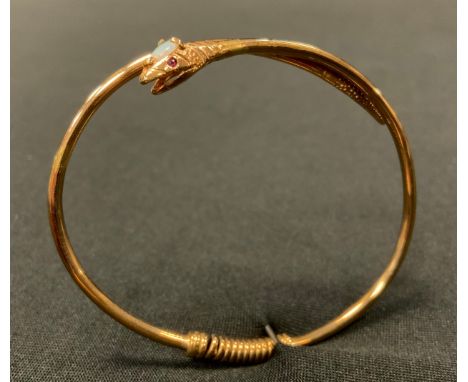 A 9ct gold snake bangle, the head inset with a single opal and two pale pink ruby eyes, 9ct gold tubular body, Birmingham 198