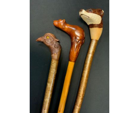 A Coppice Hazel walking stick, the finely carved pommel as the head of a male Pheasant, 123cm long;  another, the pommel carv