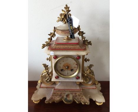 A stylish alabaster and inlaid French mantle clock on bracket feet. Est. £100 - £150.