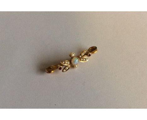 An opal and ruby bar brooch in 15 carat. Approx. 2.4 grams. Est. £70 - £80.