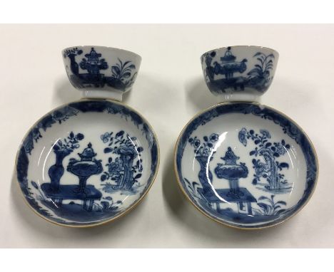 A pair of Chinese blue and white tea bowls and saucers with floral decoration. Est. £40 - £60.