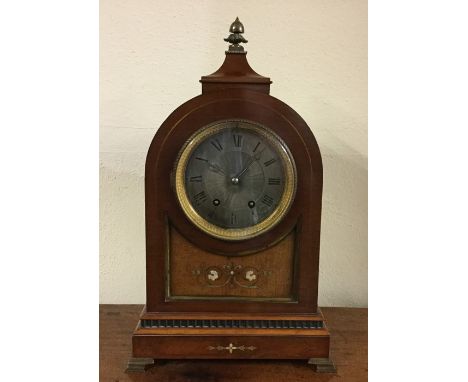 An Edwardian inlaid mahogany dome top mantle clock on brass bracket feet to silvered dial. Est. £100 - £150.