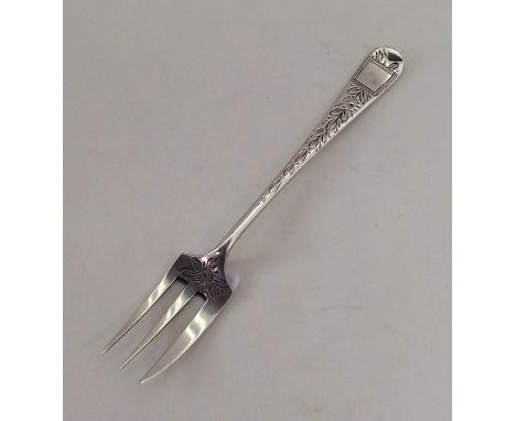An Edwardian silver pickle fork engraved with flowers. Chester. By HT. Approx.12 grams. Est. £10 - £20.