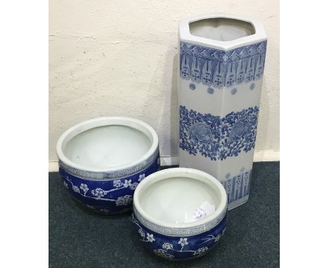 Two large blue and white planters together with a stick stand. Est. £20 - £30.