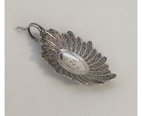 An unusual silver caddy spoon of scroll form with weave handle. Approx. 6.6 grams. Est. £50 - £80.