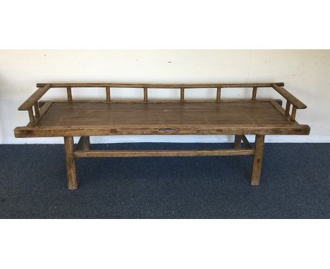 A hardwood bench on tapering supports. Est. £20 - £30.