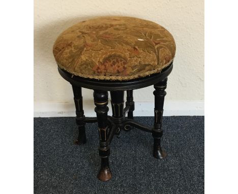 An ebony and tapestry stool. Est. £20 - £30.