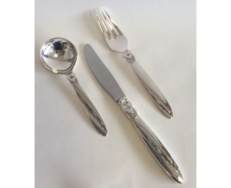 GEORG JENSEN: A good three piece single place cutlery set comprising a knife, fork and spoon of typical form. Approx. 201 gra