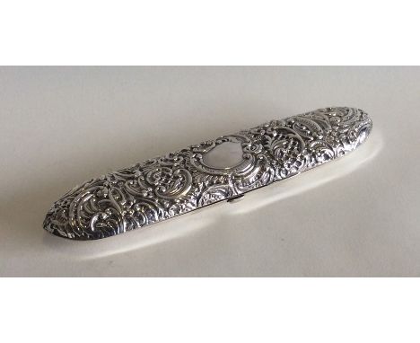 A canoe shaped embossed silver box decorated with scrolls and flowers. Birmingham. By IS. Approx. 65 grams. Est. £80 - £120.