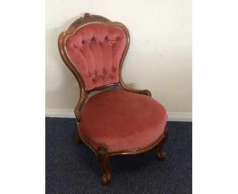 A pink upholstered button back nursing chair. Est. £40 - £60.