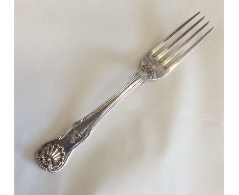 A silver dessert fork with shell decoration. London. By WE. Approx. 63 grams. Est. £20 - £30.
